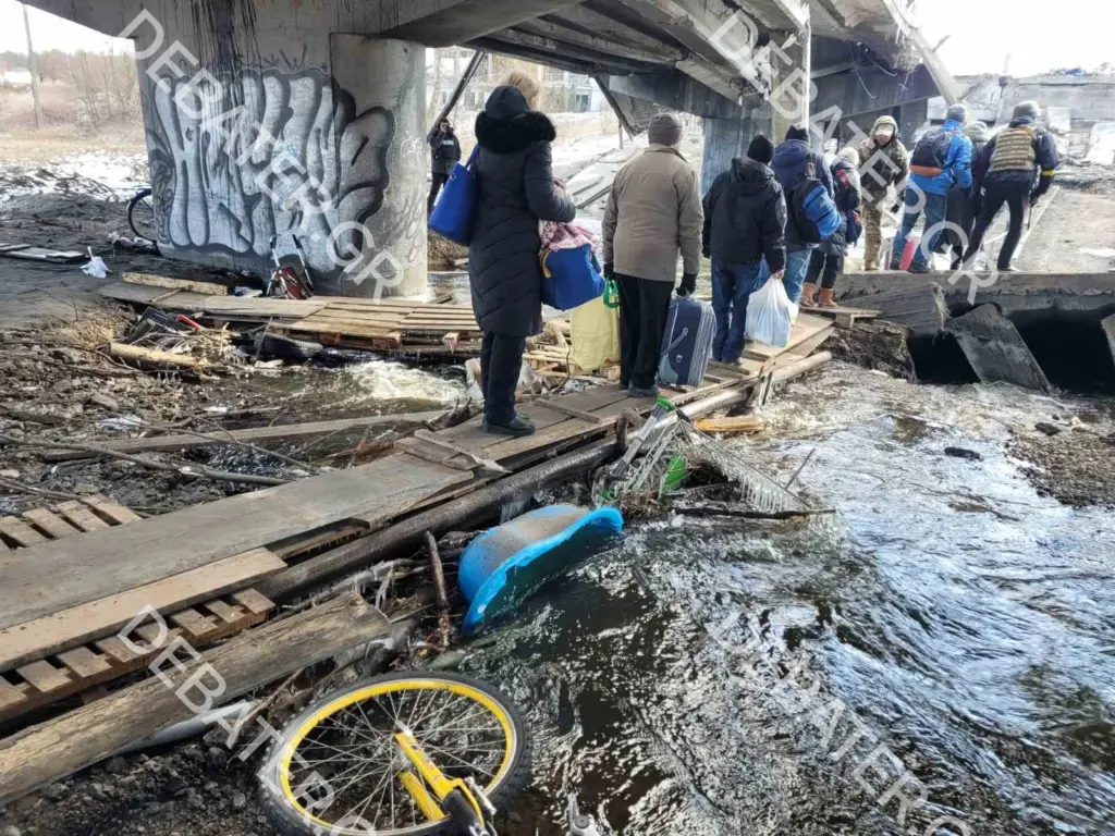 Με κάθε τρόπο εγκαταλείπουν το Ιρπίν – Άμαχοι με τα λιγοστά υπάρχοντά τους περνούν κάτω από συντρίμμια γέφυρας (pics)